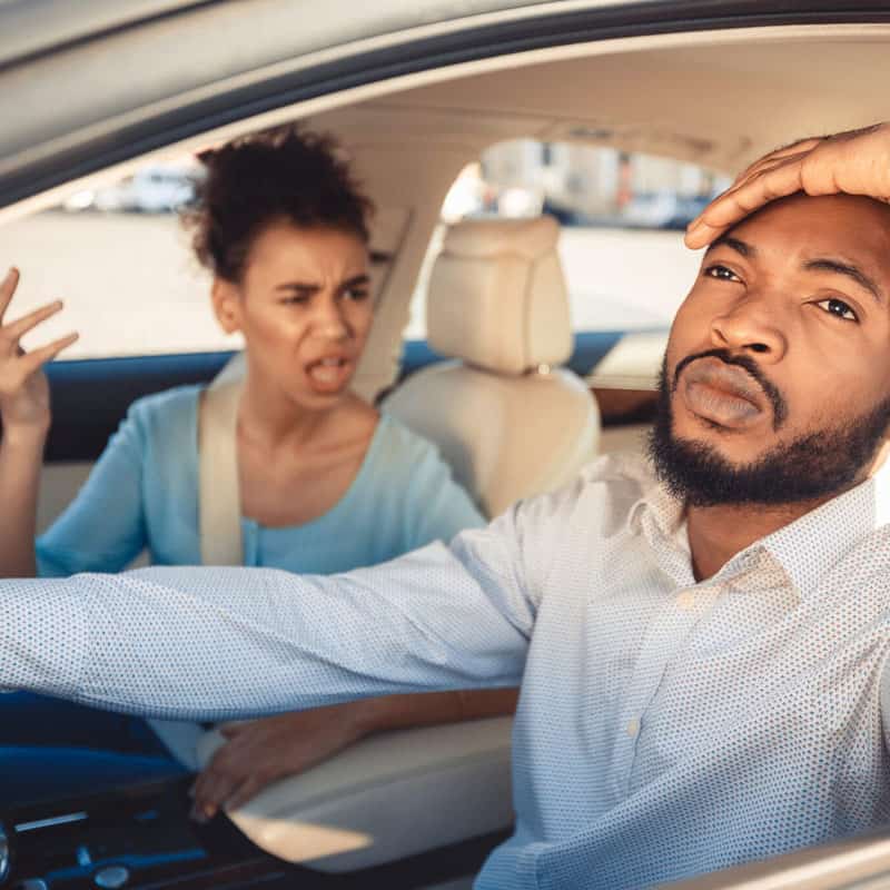 An image of a couple arguing in the car.