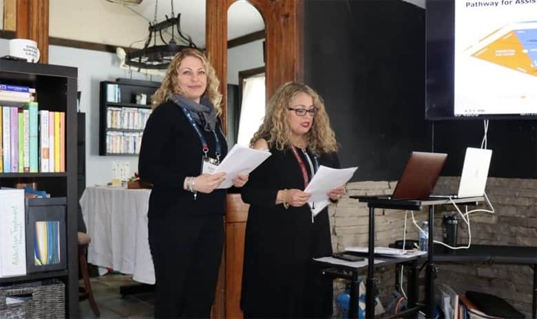 Mirella Corallo and Gloria Segovia lead the study group reading the course materials.