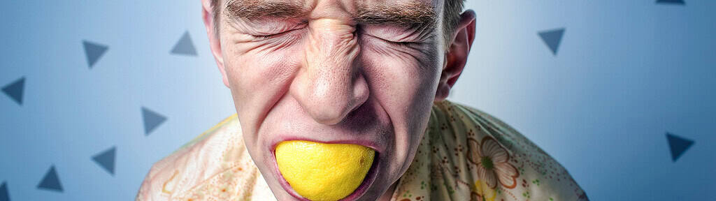 A stressed individual biting a lemon, symbolizing anxiety and stress, with a focus on EMDR therapy for professionals in Toronto and the GTA.