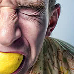 A stressed individual biting a lemon, symbolizing anxiety and stress, with a focus on EMDR therapy for professionals in Toronto and the GTA.