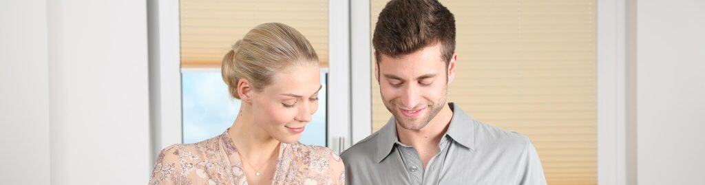 Smiling couple cooking together in a modern kitchen, demonstrating teamwork and positive communication in marriage.