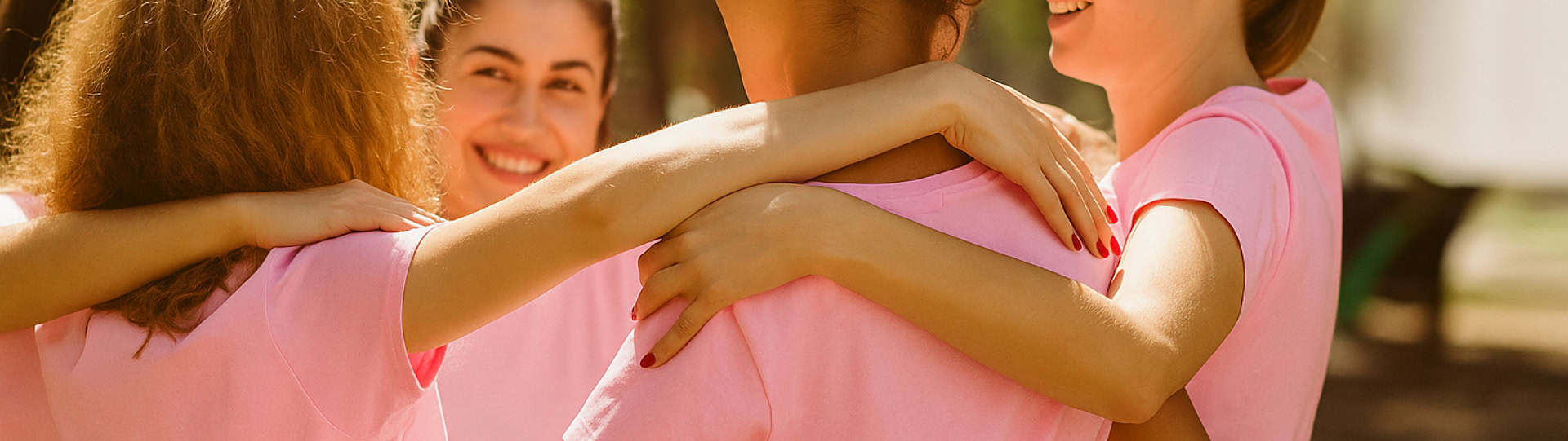 Children wearing pink shirts with arms around each other, symbolizing support and unity in raising awareness about the mental health impact of bullying.