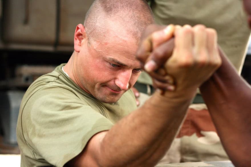Canadian veteran engaged in an arm-wrestling match, symbolizing strength, focus, and the role of mindfulness for veterans in building mental resilience. Canadian veteran engaged in an arm-wrestling match, symbolizing strength, focus, and the role of mindfulness for veterans in building mental resilience.