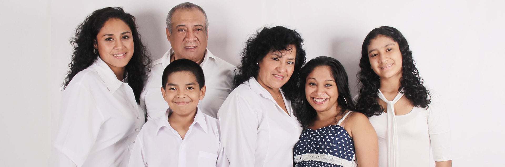Smiling multigenerational family standing together in unity, symbolizing the healing and connection nurtured through spiritual therapy. Smiling multigenerational family standing together in unity, symbolizing the healing and connection nurtured through spiritual therapy.