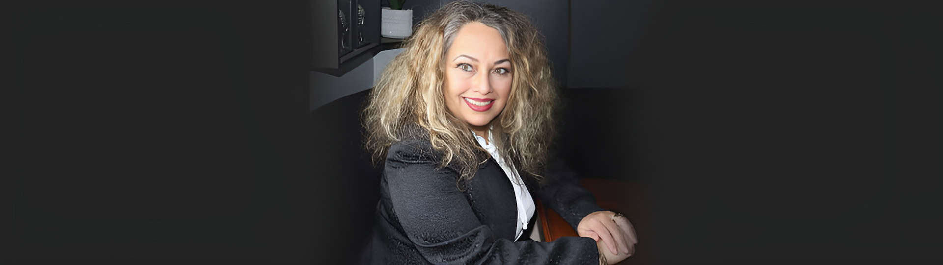 Gloria Segovia, founder of AERCS Therapy, smiling warmly in a professional setting, dedicated to guiding individuals through healing and personal growth.