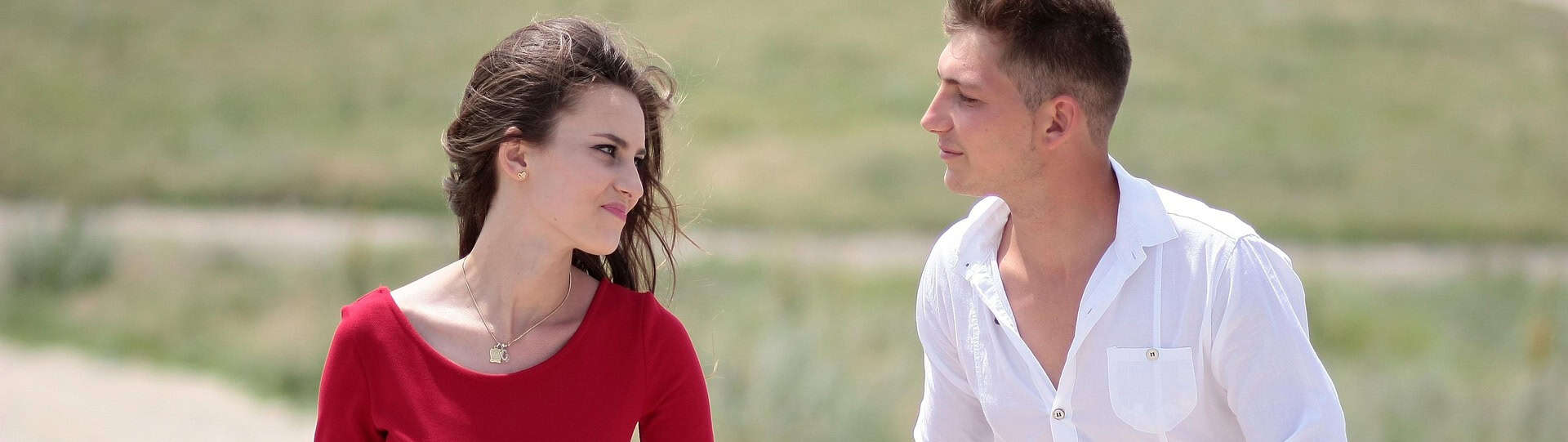 Young couple walking outdoors having a thoughtful conversation, representing emotional investment and the real-life value behind couples therapy cost.