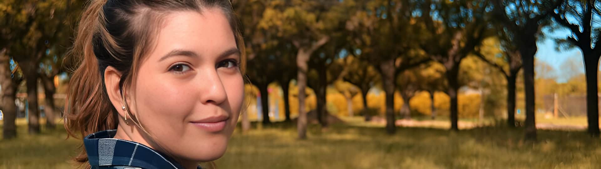 Woman stitting in a peaceful park setting, symbolizing clarity and healing, representing how EMDR therapy differs from Trauma-Informed approaches.