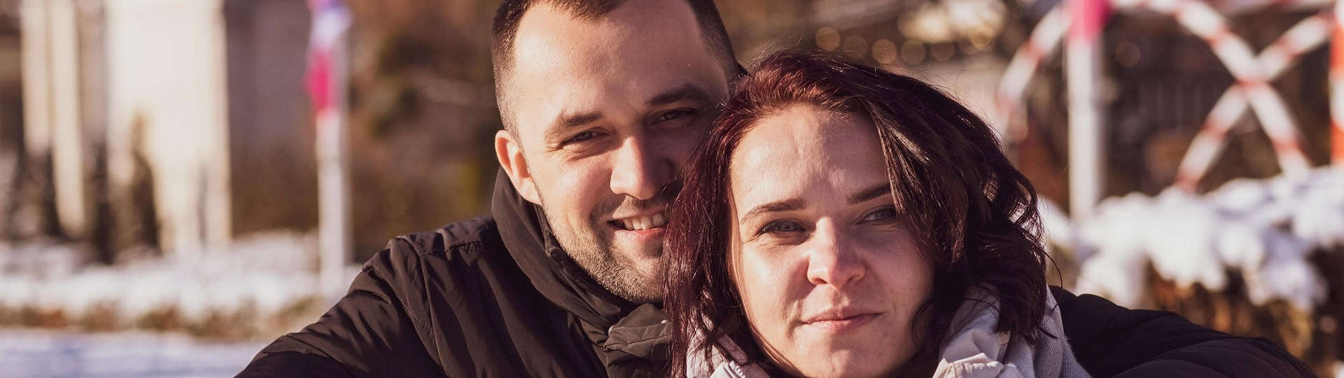Couple embracing outdoors, symbolising emotional connection and trust, key to efforts to convince a partner to attend therapy together.