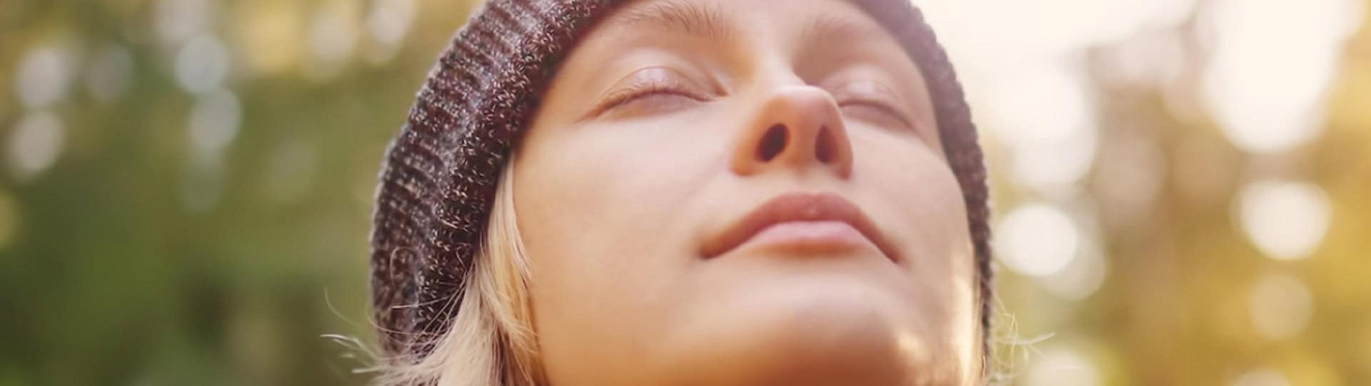 Close-up of a peaceful woman outdoors with eyes closed, practising 4‑7‑8 breathing to reduce anxiety and promote relaxation through mindful breathwork.