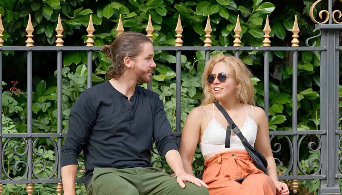 Couple sitting together on a bench having a conversation, representing emotional reconnection and trust rebuilding in infidelity counselling. Couple sitting together on a bench having a conversation, representing emotional reconnection and trust rebuilding in infidelity counselling.