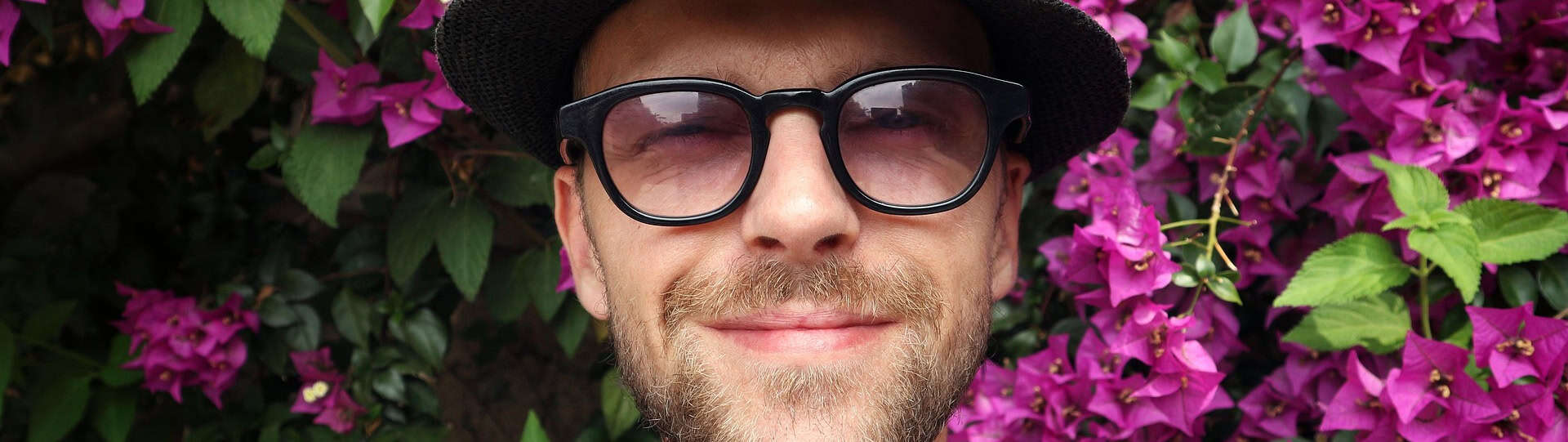 Smiling man outdoors looking relaxed and confident, representing positive changes after starting anxiety therapy.